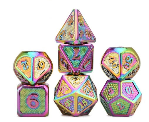 Set of colorful metal dice with dragon design on a white background