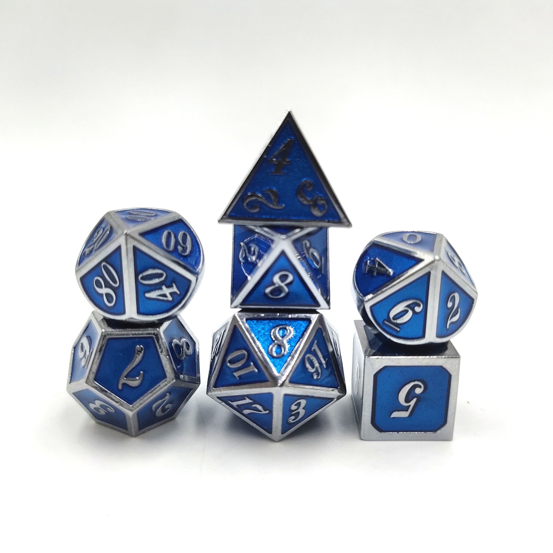 Set of blue and silver polyhedral dice on a white background