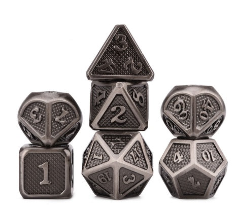 Set of metallic polyhedral dice on a white background