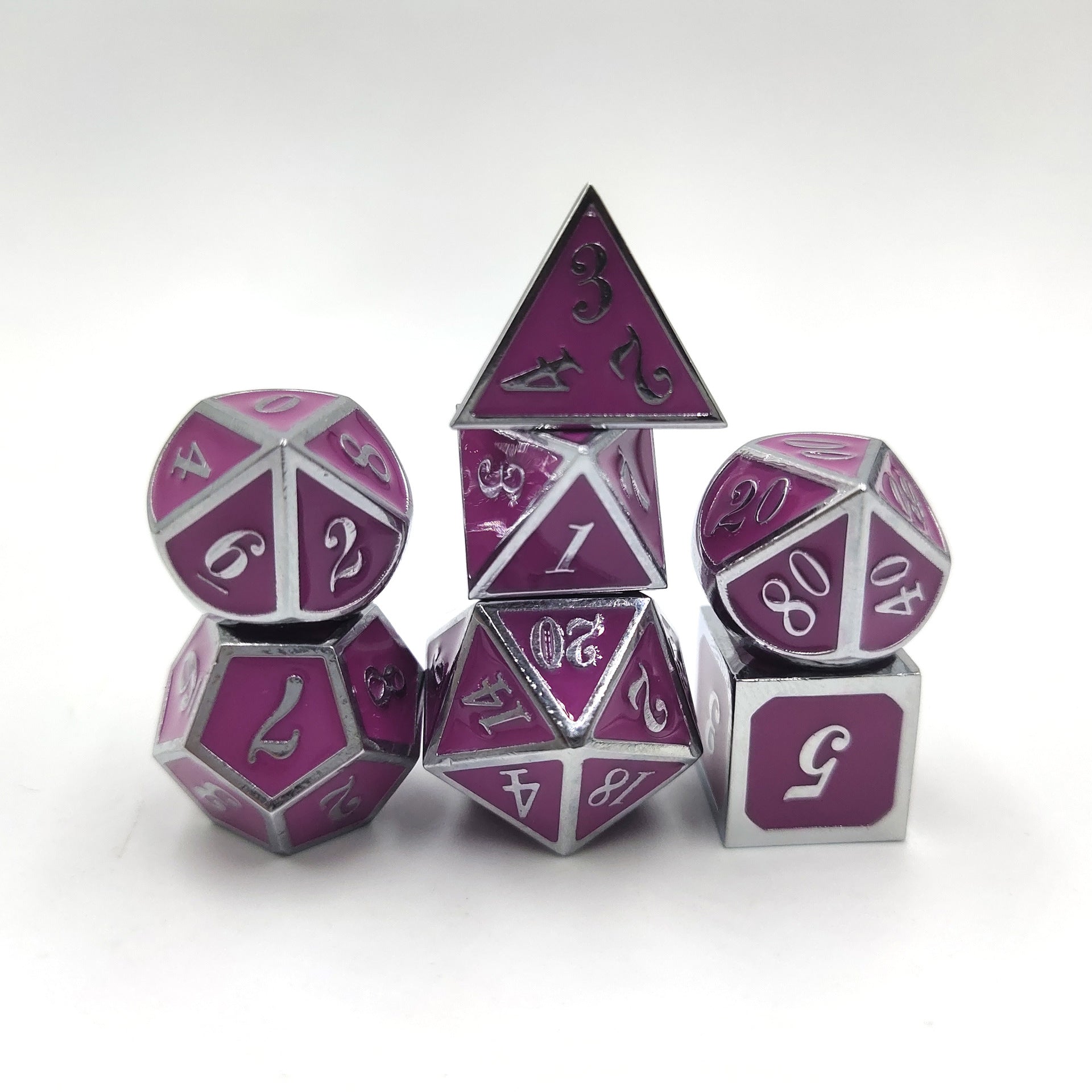 Set of purple and silver polyhedral dice on a white background