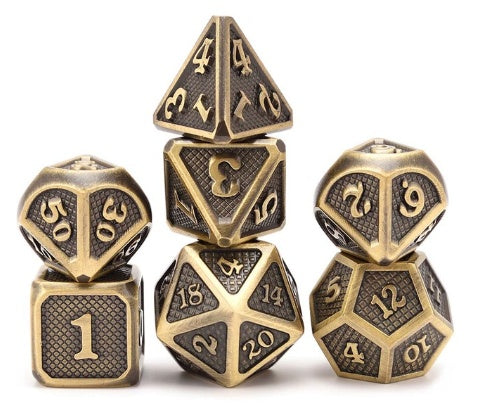 Set of metallic polyhedral dice with embossed numbers on a white background