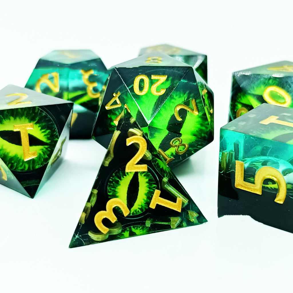 Set of green and black polyhedral dice with yellow numbers on a white background