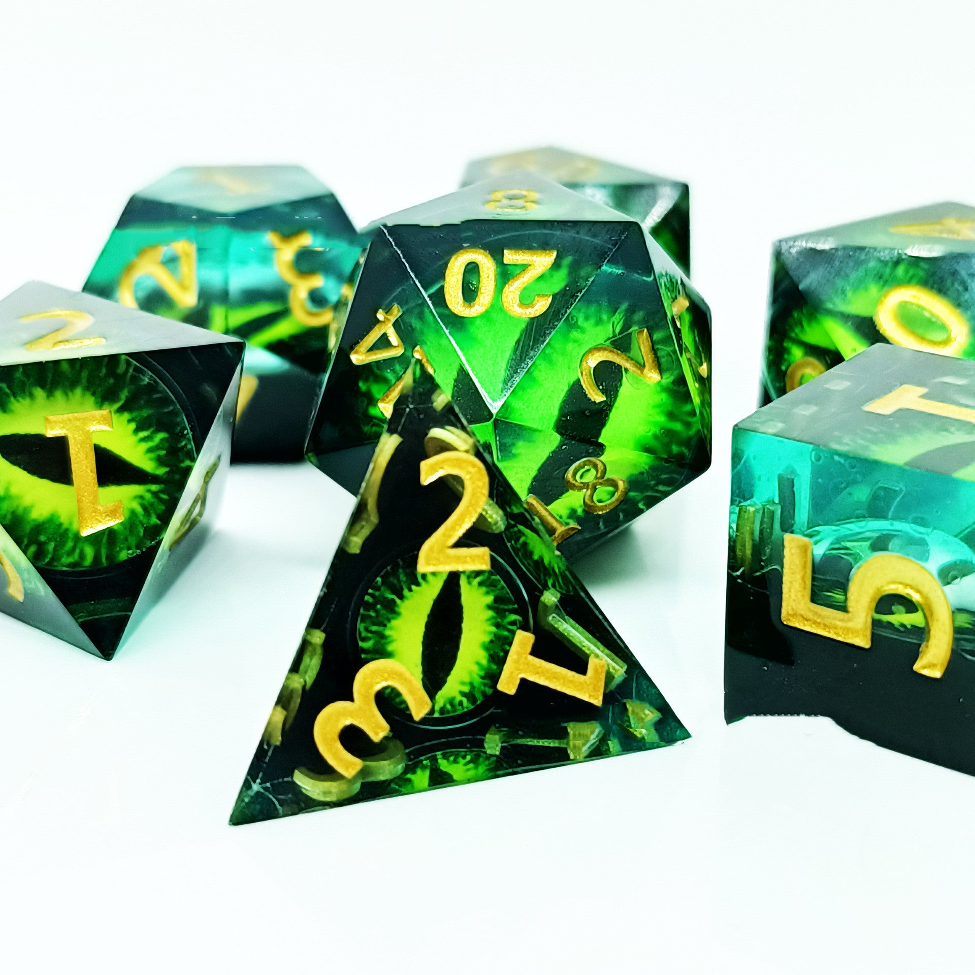 Set of green and black polyhedral dice with yellow numbers on a white background