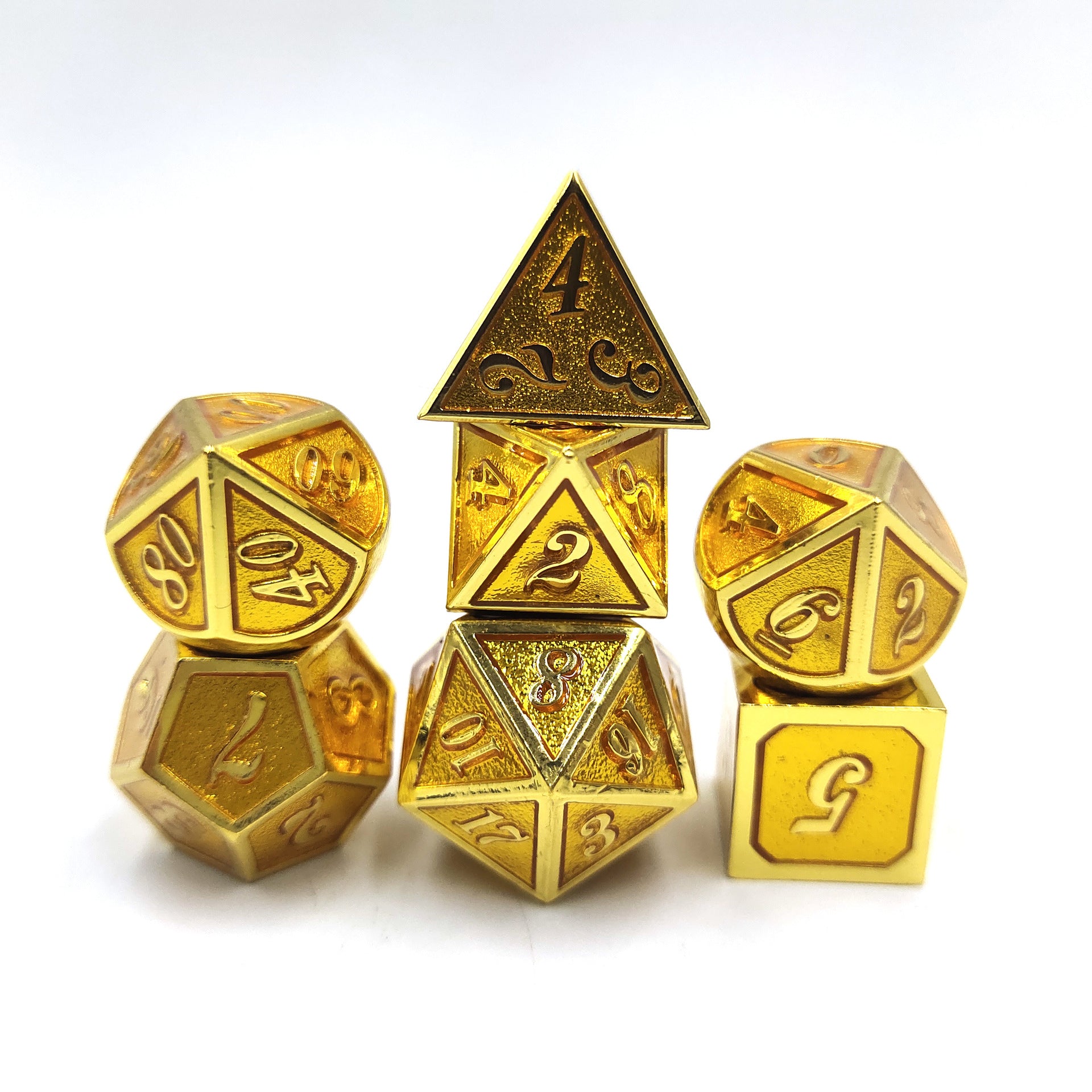 Set of gold polyhedral dice on a white background